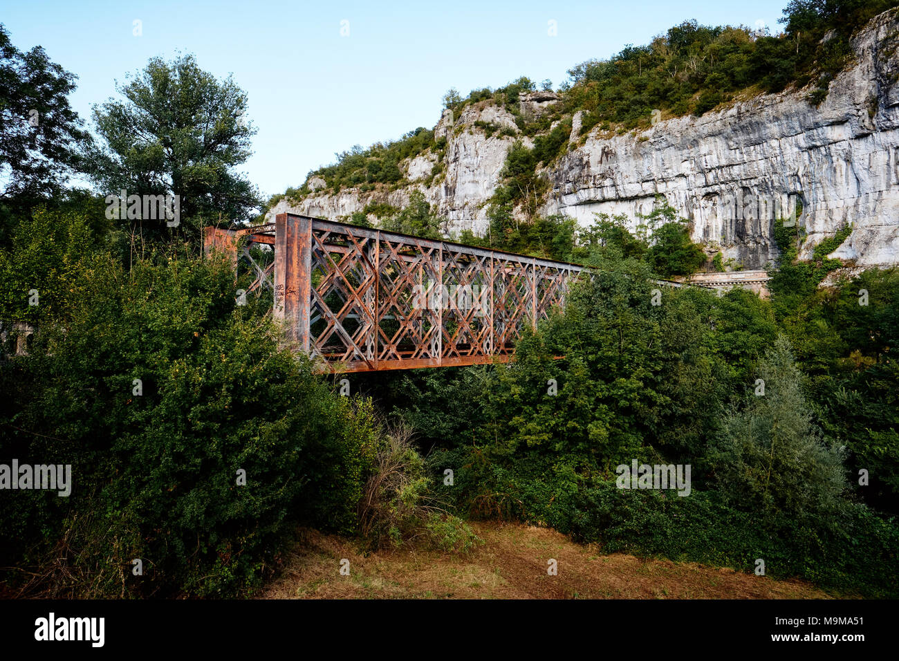 An old metal railway bridge in the Lot region of France now disused. Stock Photo