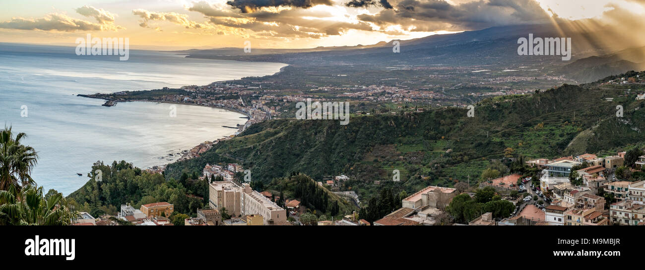 Clouds and sun around the Etna volcano. Taken from Taormina, Messina, Sicily, Italy. Stock Photo