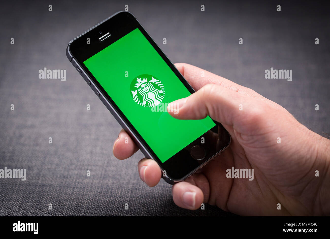 Using the Starbucks App on a iPhone Stock Photo