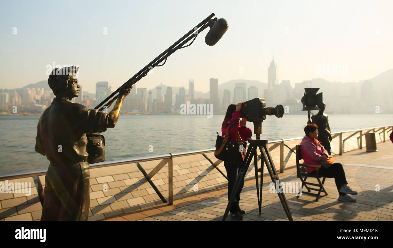 Hong Kong, China - January 1, 2016: Avenue of stars on the island of Kowloon in Hong Kong. The Hong Kong film industry is a famous landmark of the city. Sculptures of people taking a film. Stock Photo