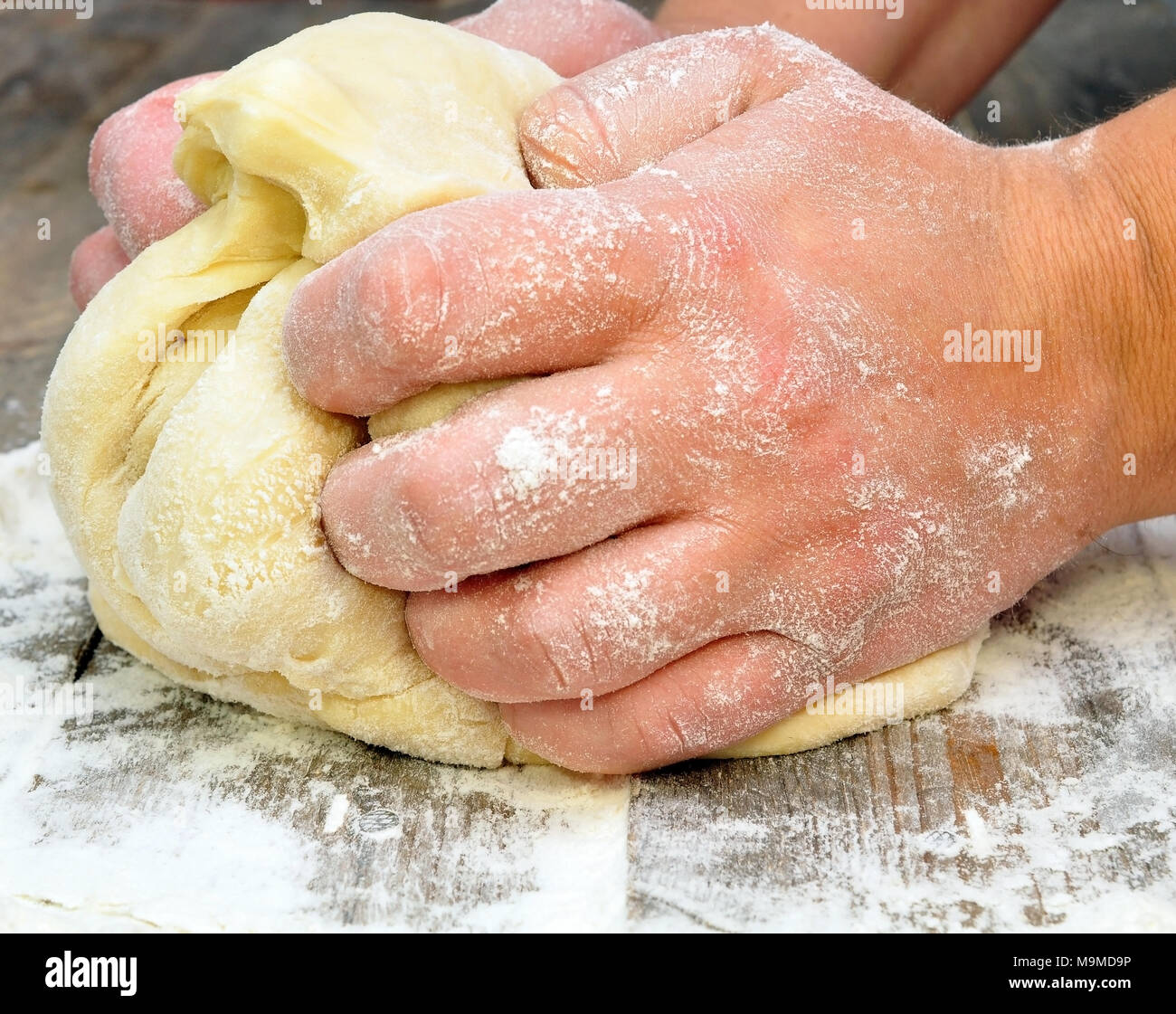 female hand kneads dough Stock Photo