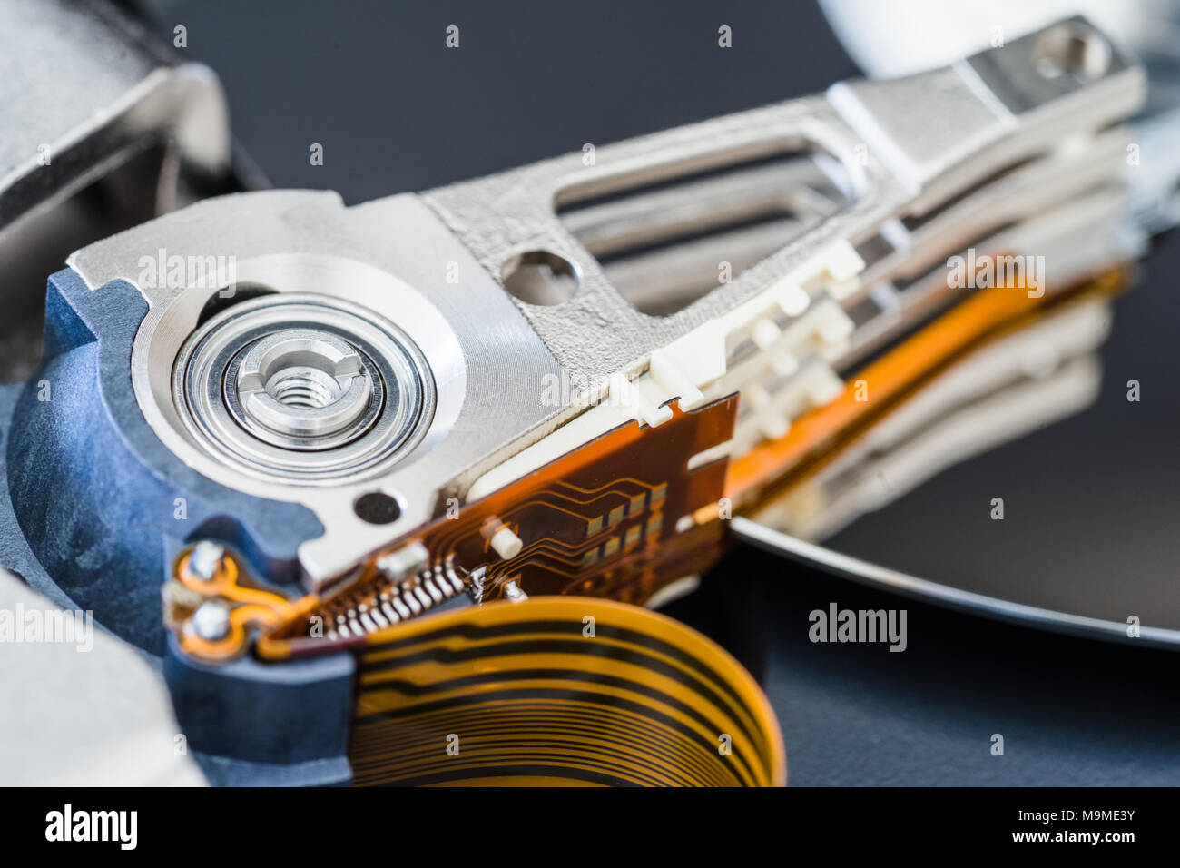 Hard disk drive inside close-up, actuator arm, read write head, ribbon  cable Stock Photo - Alamy