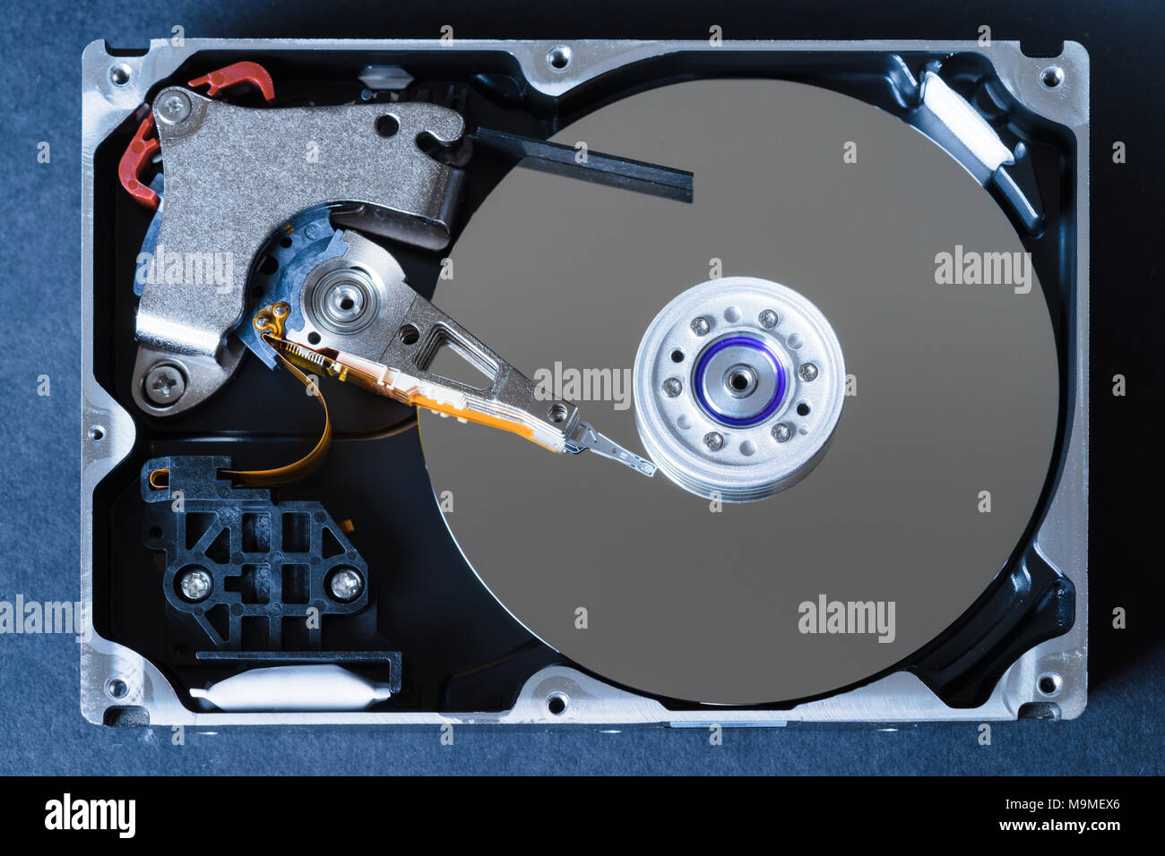 Hard disk drive with removed cover, hdd inside flat view, spindle, actuator  arm, read write head, platter, ribbon cable Stock Photo - Alamy