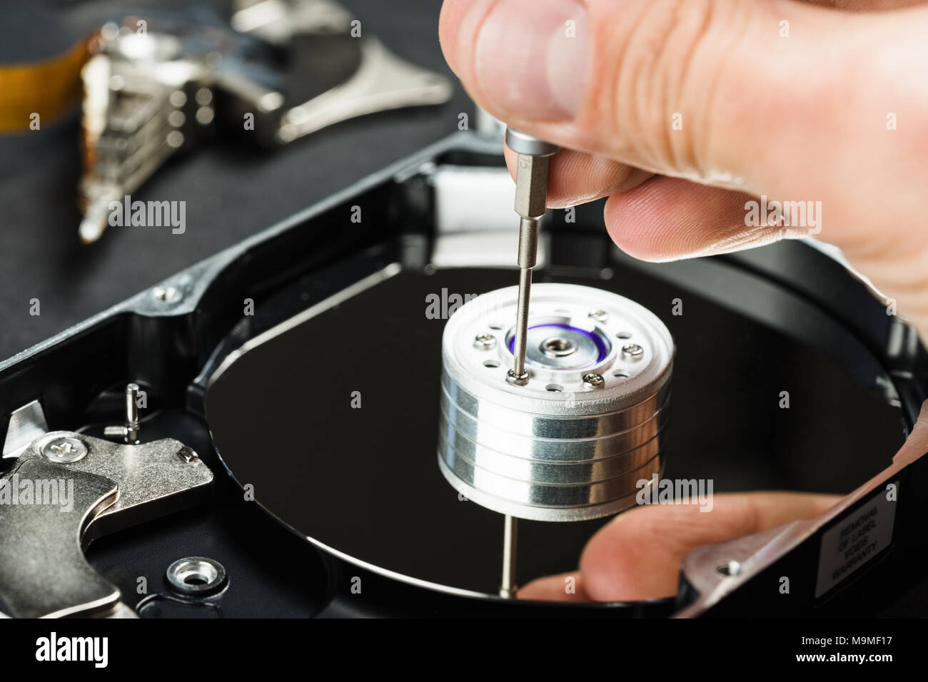 Repairman disassembling hard disc drive hdd close-up. Stock Photo