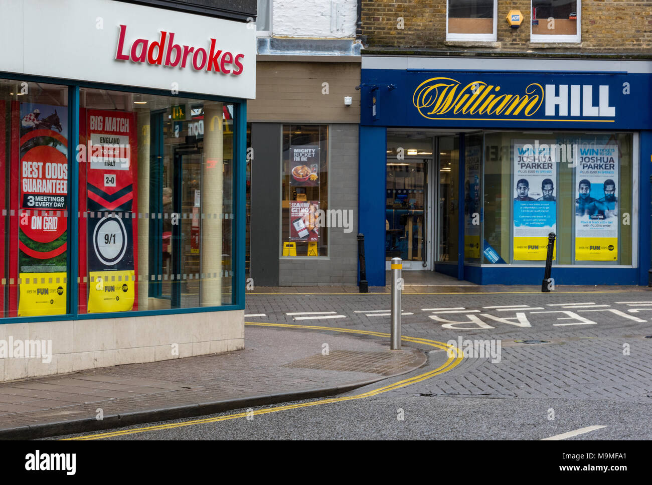 Betting shops or bookies premises in the high street for gamblers and gambling money and horse racing football odds. Addictions and bad habits money. Stock Photo