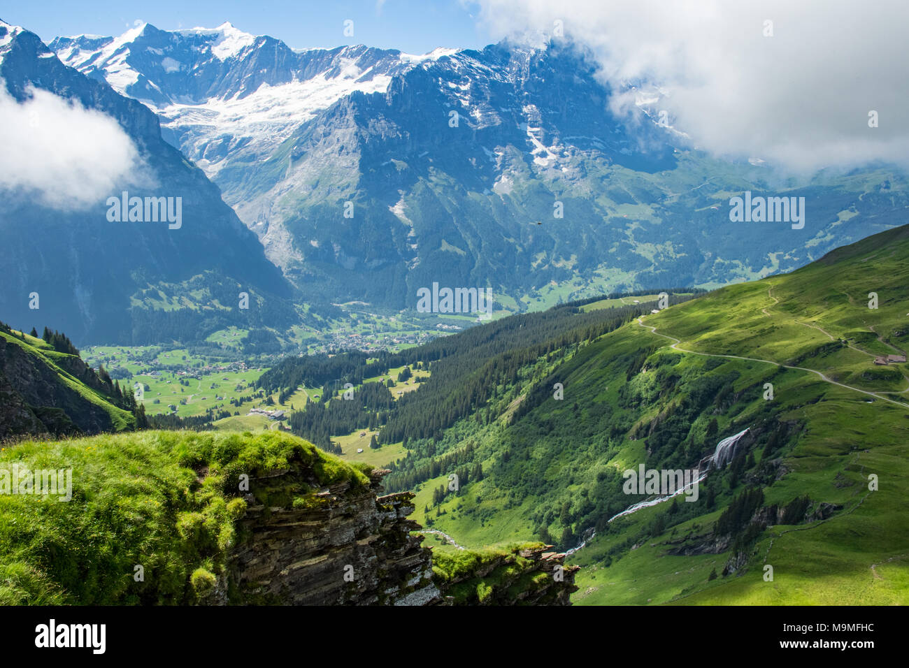 Swiss Countryside With Snow Capped Mountains and Waterfalls in Grindelwald, Switzerland Stock