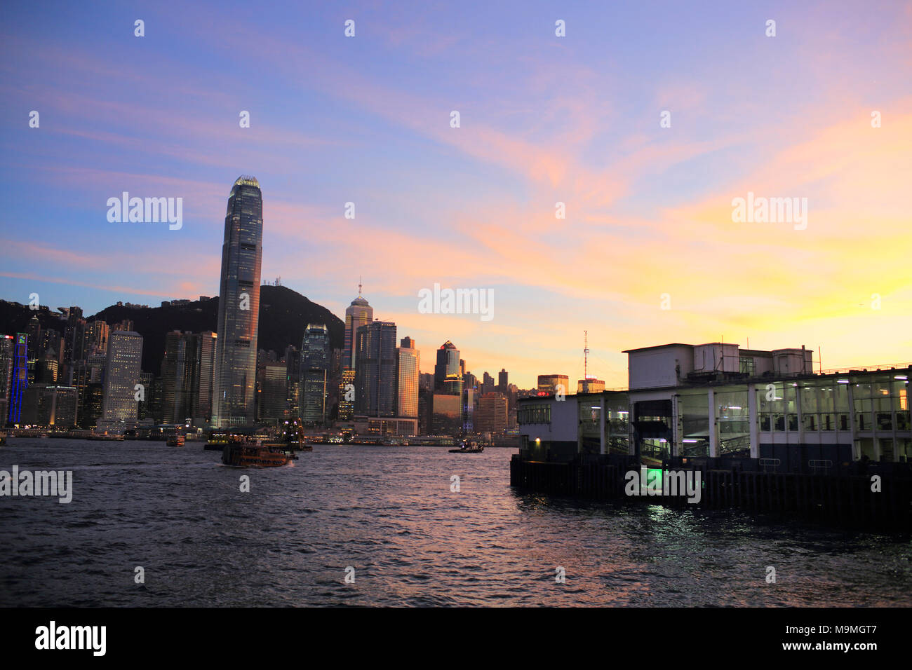 Hong Kong victoria harbour skyline in sunset glow Stock Photo - Alamy
