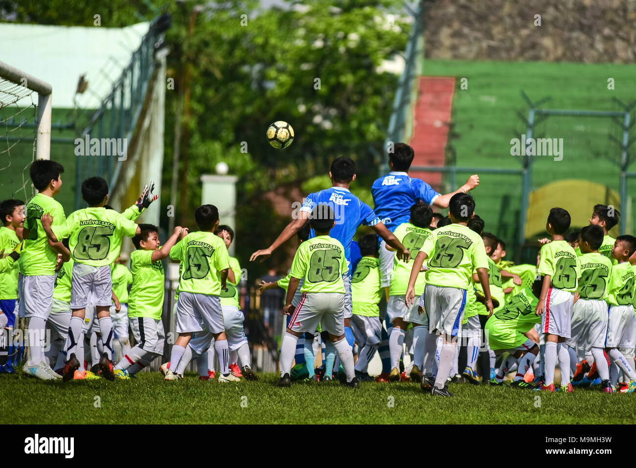 Five players of Indonesian football club of Persib Bandung play against 85 children in an exhibition match to celebrate its 85th anniversary. Stock Photo