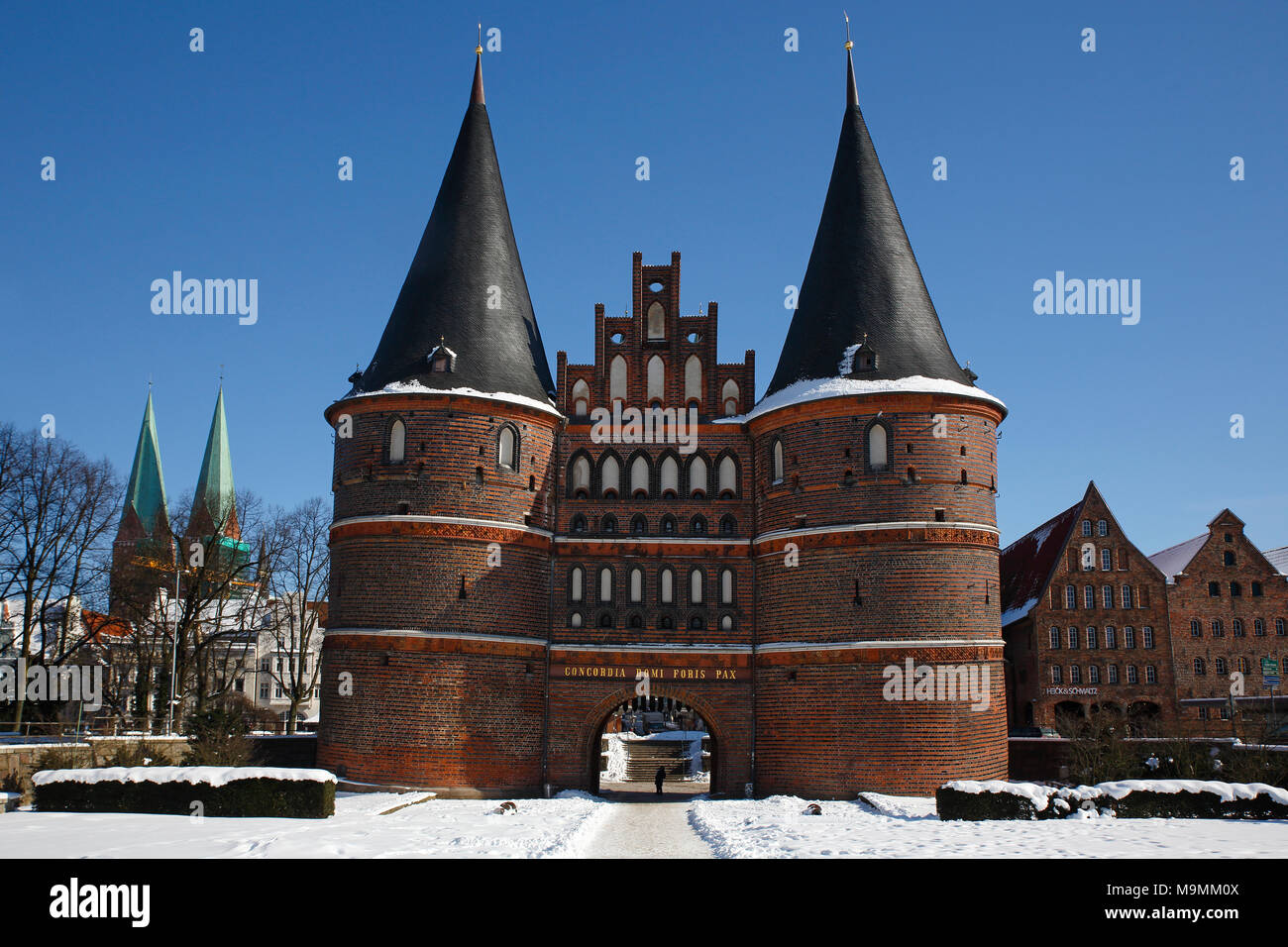 Holstentor in winter in the snow, Salzspeicher and church St. Petri, Lübeck, Schleswig-Holstein, Germany Stock Photo