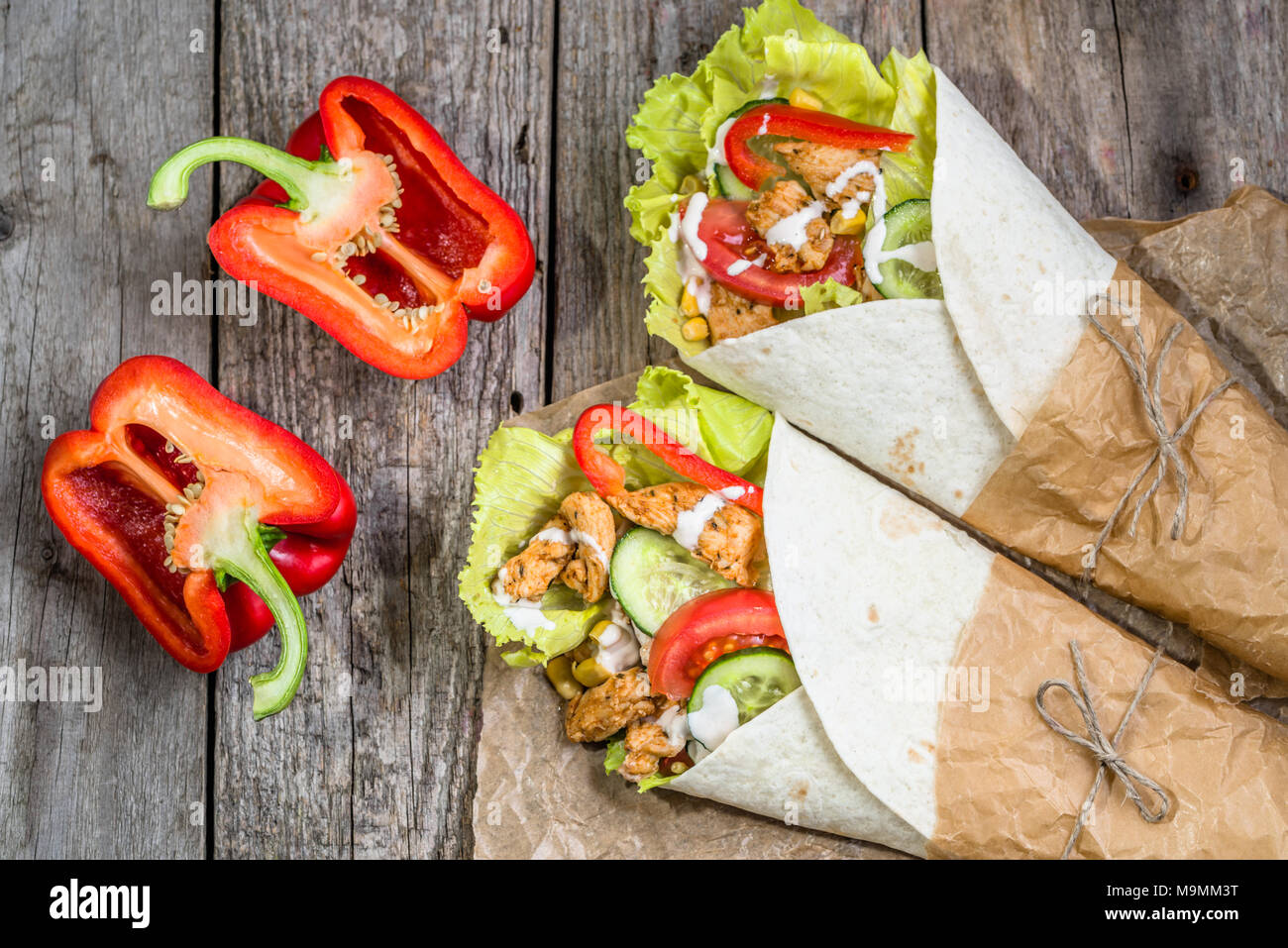 Tortilla wraps with fresh vegetables and grilled chicken meat, tex-mex cuisine Stock Photo