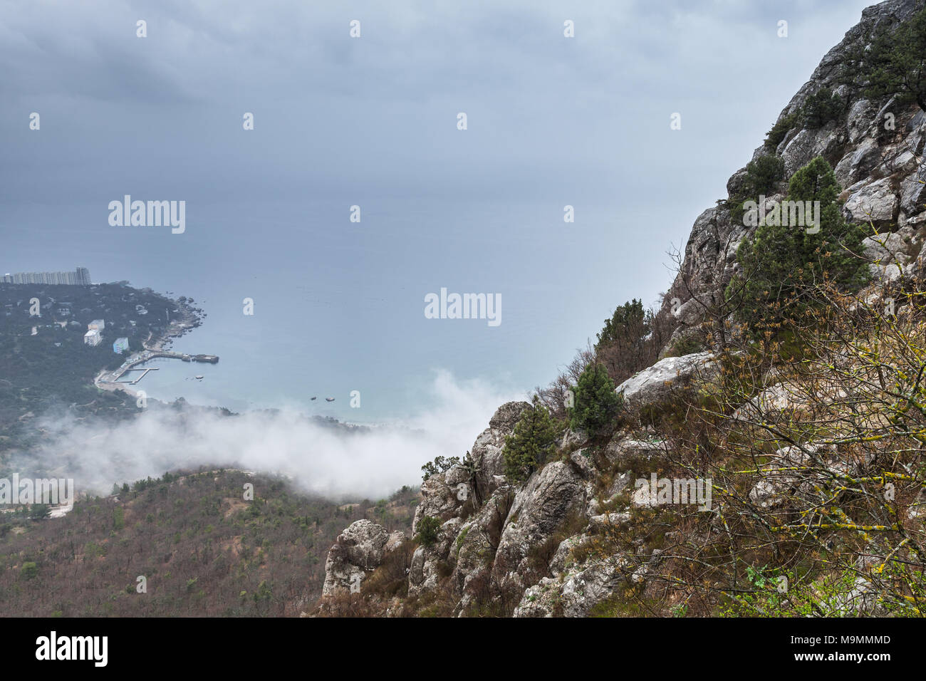 Crimea, Black Sea coast. Rocks and clouds. Landscape of Laspi in foggy spring morning Stock Photo