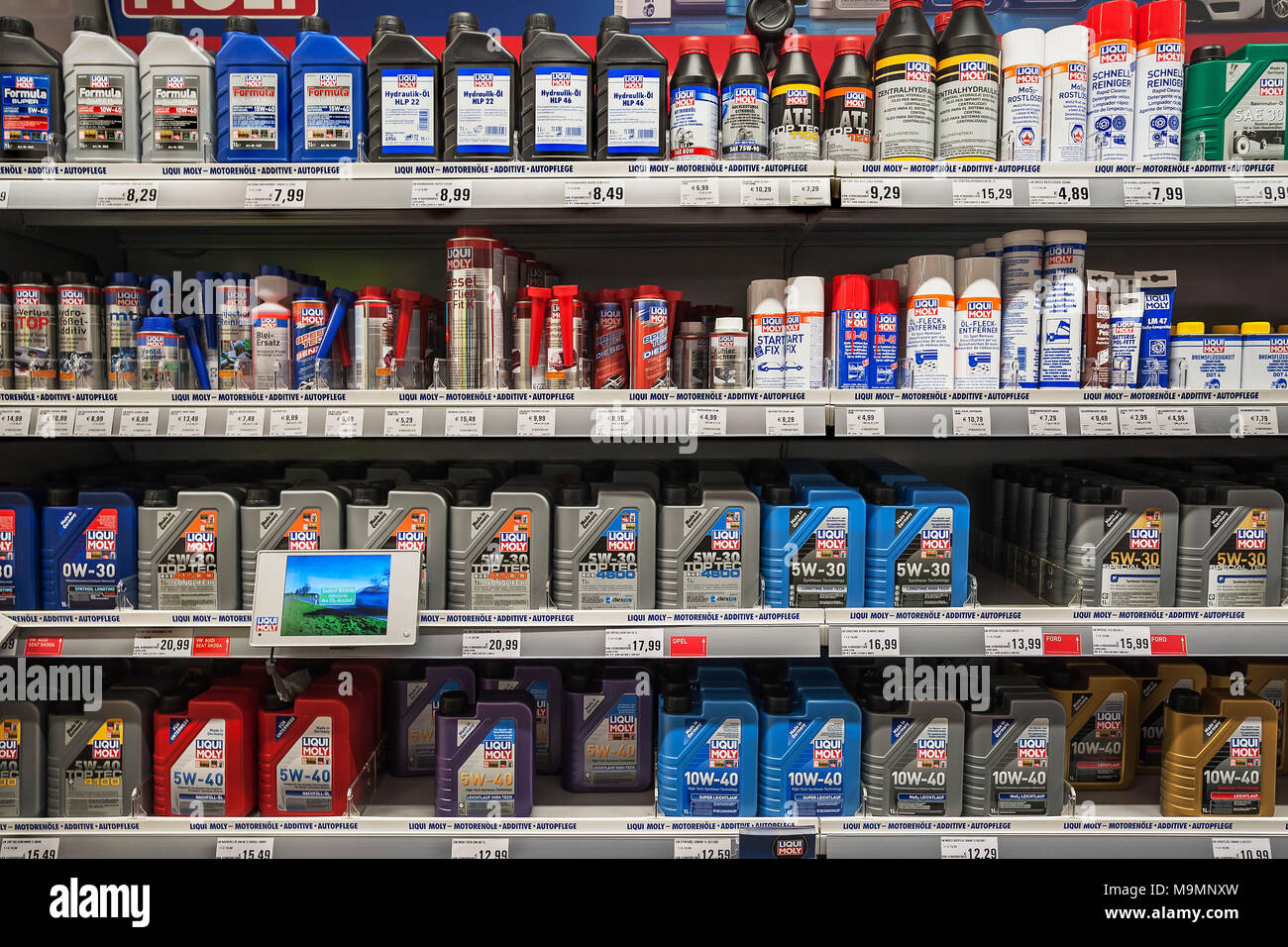 Shelf with engine oil, car care products, hardware store, interior