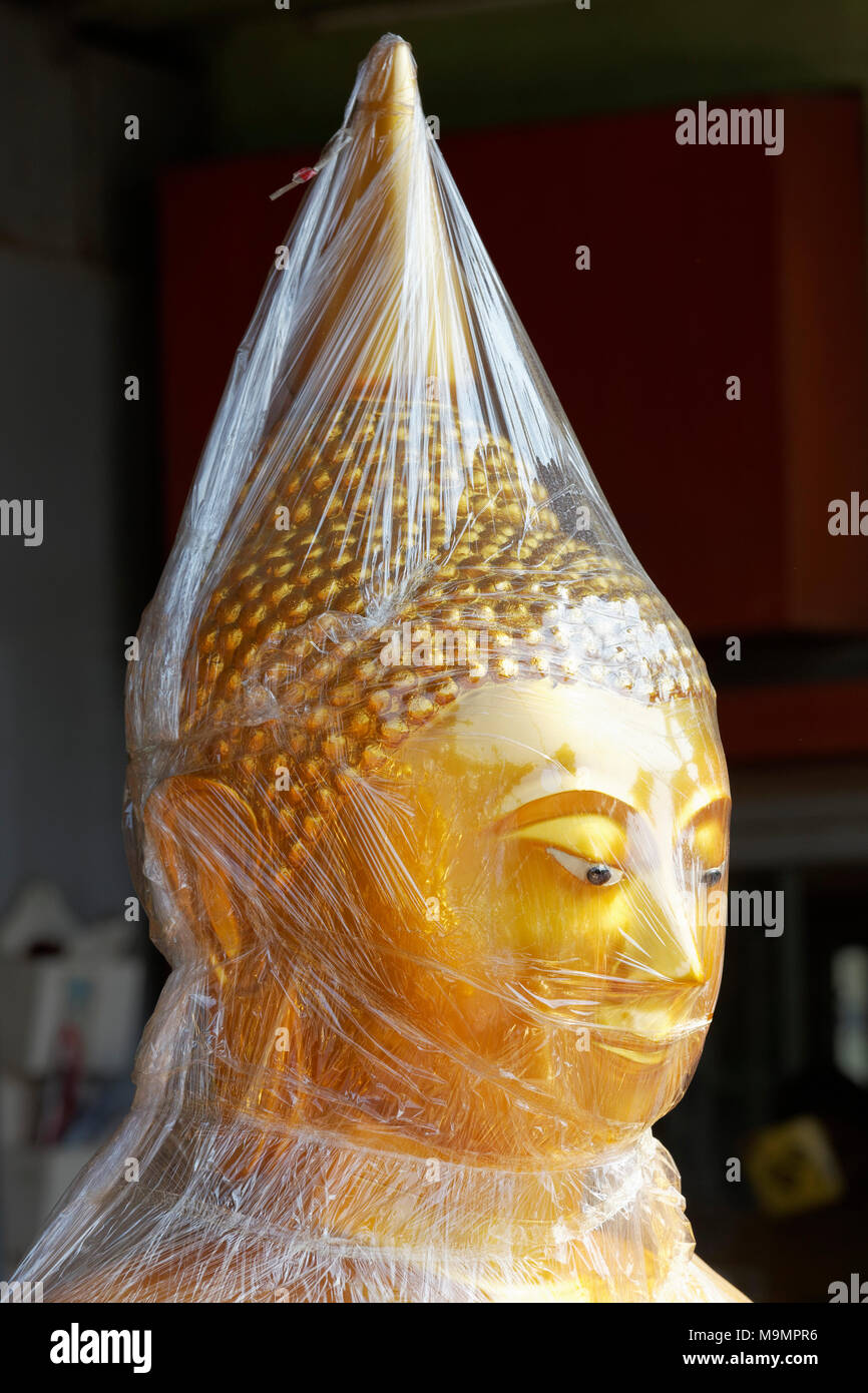 Buddha statue in foil, for sale, devotional business in the Buddha Road, Thanon Bamrung Meuang, Phra Nakhon, Bangkok, Thailand Stock Photo