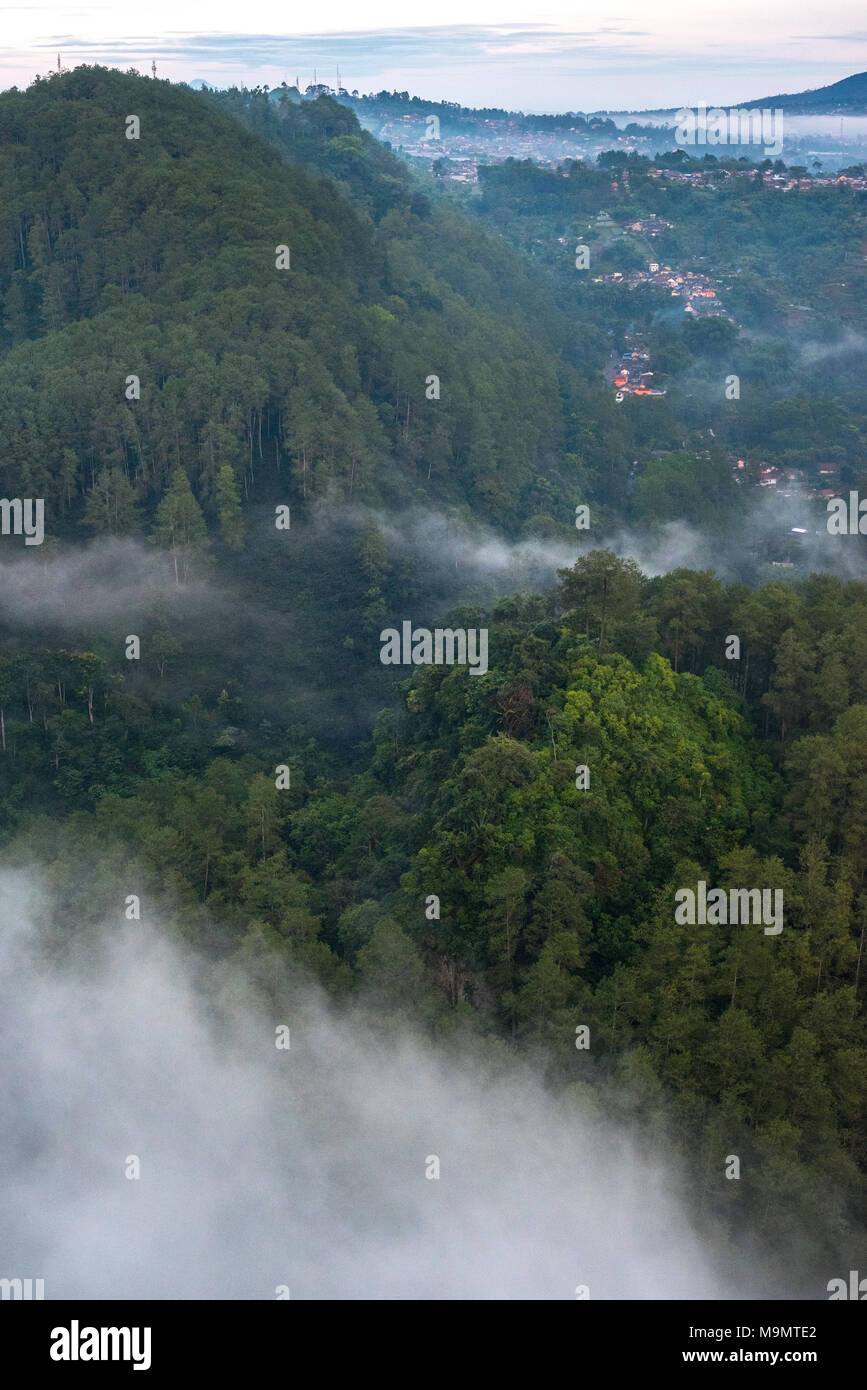 Narrow valley across hilly landscape of Lembang City in the north of Bandung Basin, West Java, Indonesia. Stock Photo