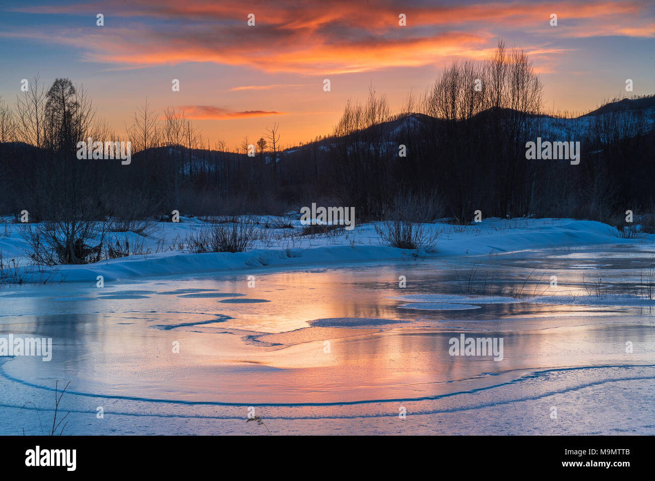 Icy landscape with dramatic sunset, Tuul river, Gorkhi-Terelj National Park, Mongolia Stock Photo