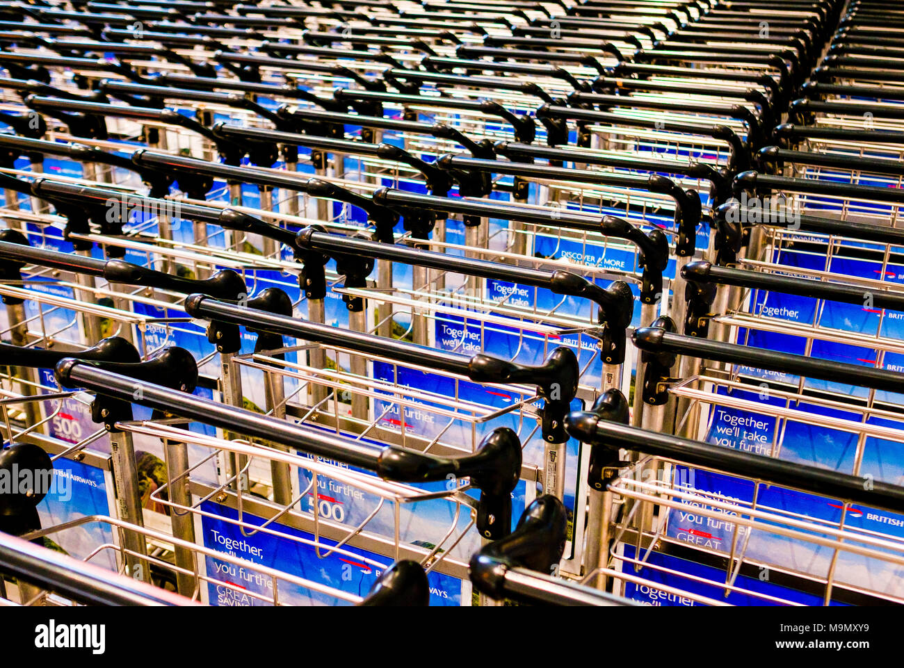 Baggage carts in line, Heathrow Airport, London, England, Great Britain Stock Photo