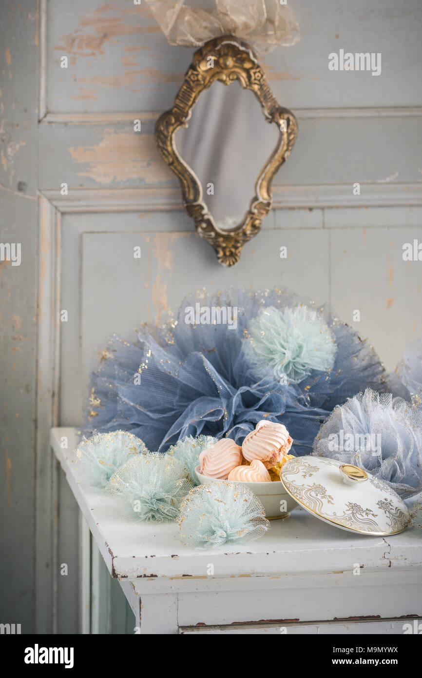 French decor with tulle pom poms and meringue. Stock Photo