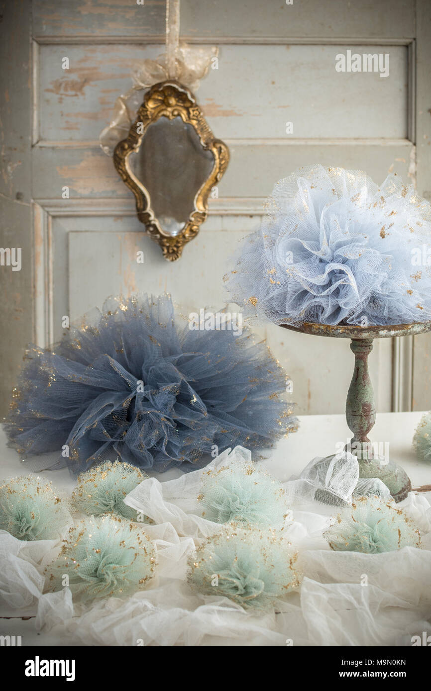 Tulle pom poms and old French mirror decoration - rustic metal cake stand Stock Photo