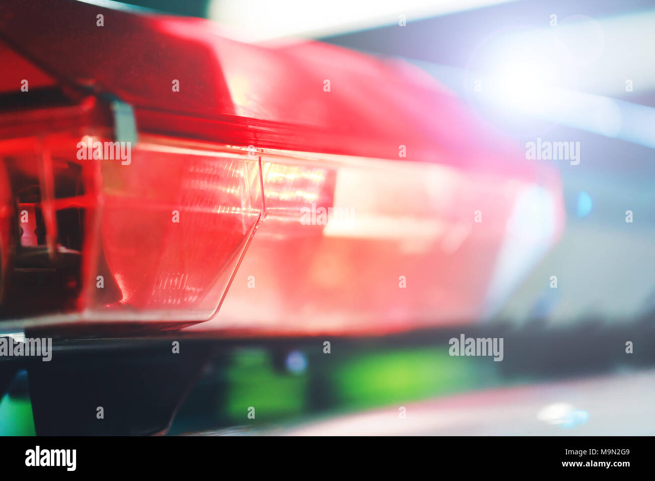 Red flasher on the police car at night. Red light flasher of a police