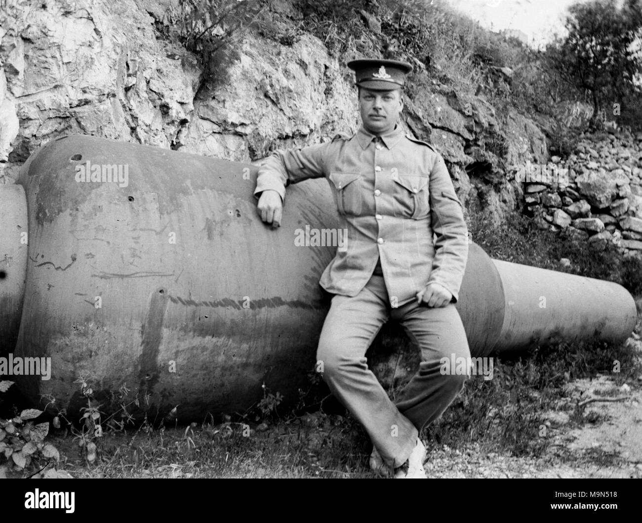 AJAXNETPHOTO. 1914-1920 (APPROX). LOCATION UNKNOWN, POSSIBLY NORTHERN FRANCE. - BRITISH ARMY L/CPL NCO SOLDIER POSING FOR THE CAMERA ON THE REMAINS OF A LARGE GUN BARREL.  PHOTOGRAPHER:UNKNOWN © DIGITAL IMAGE COPYRIGHT AJAX VINTAGE PICTURE LIBRARY SOURCE: AJAX VINTAGE PICTURE LIBRARY COLLECTION REF:182303 03 Stock Photo
