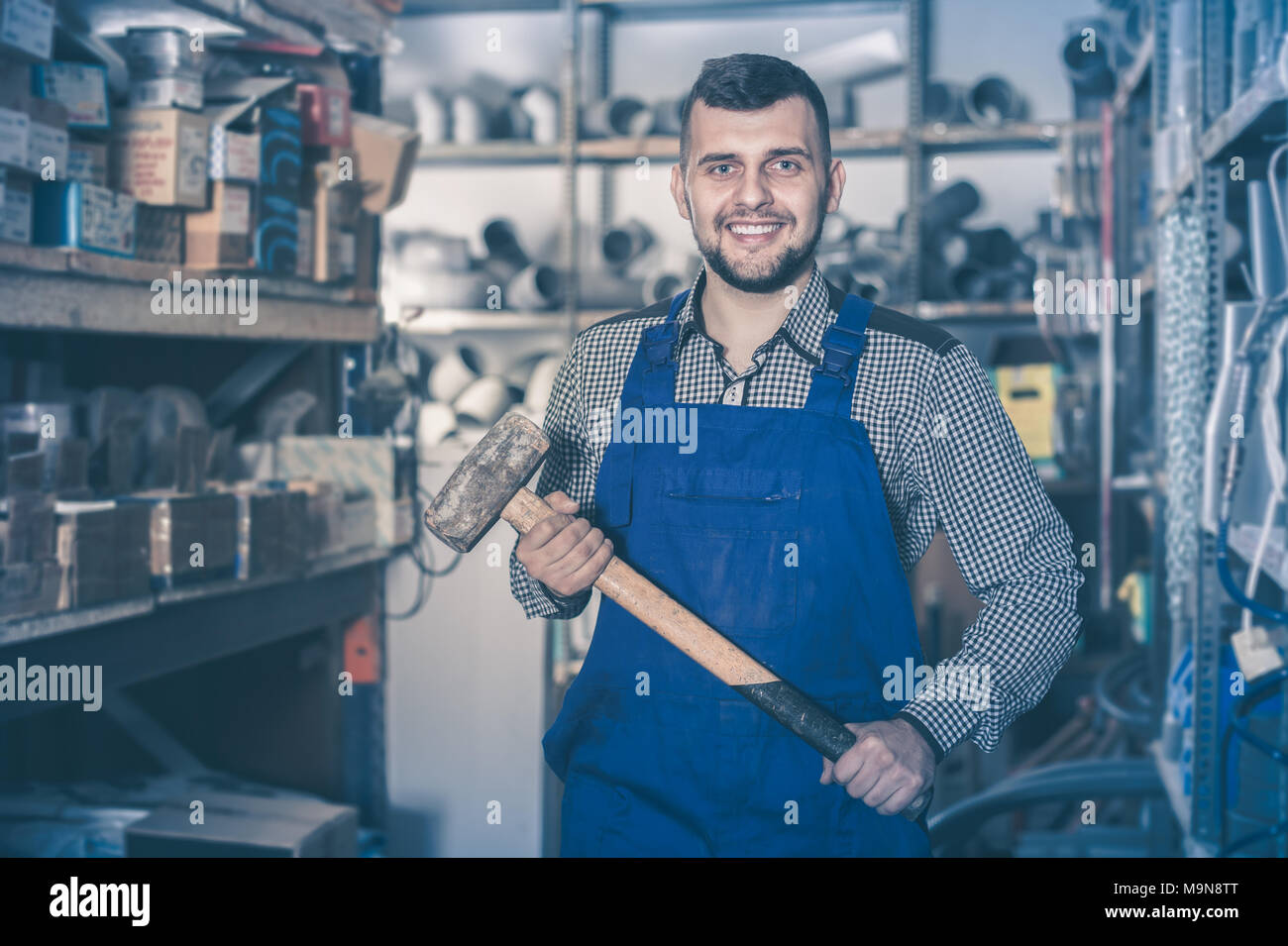Worker man showing his constructing instruments at workshop Stock Photo ...