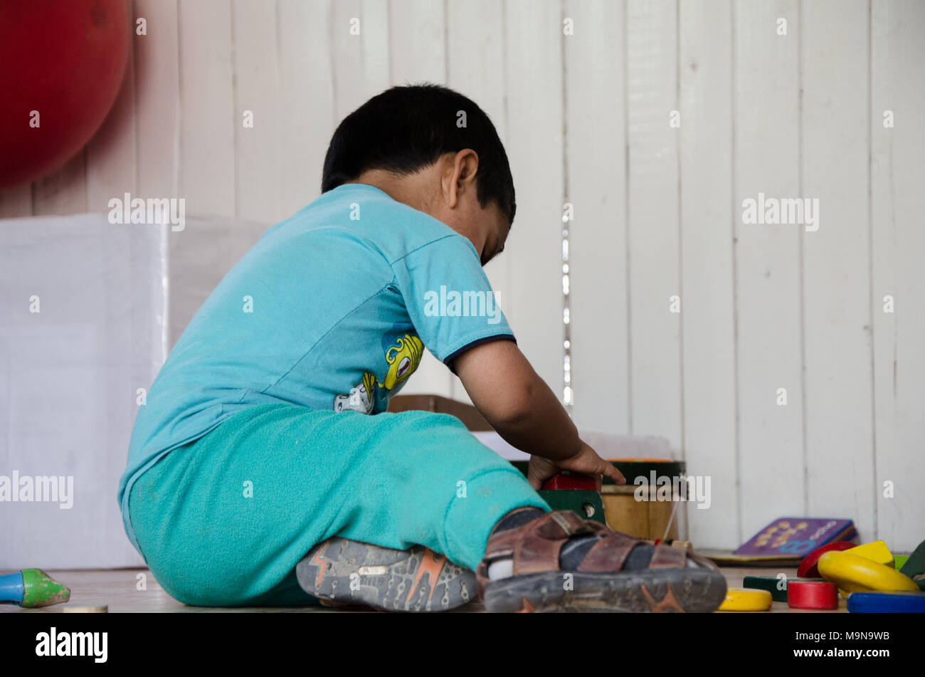 Boy playing and looking for toys in a box Stock Photo