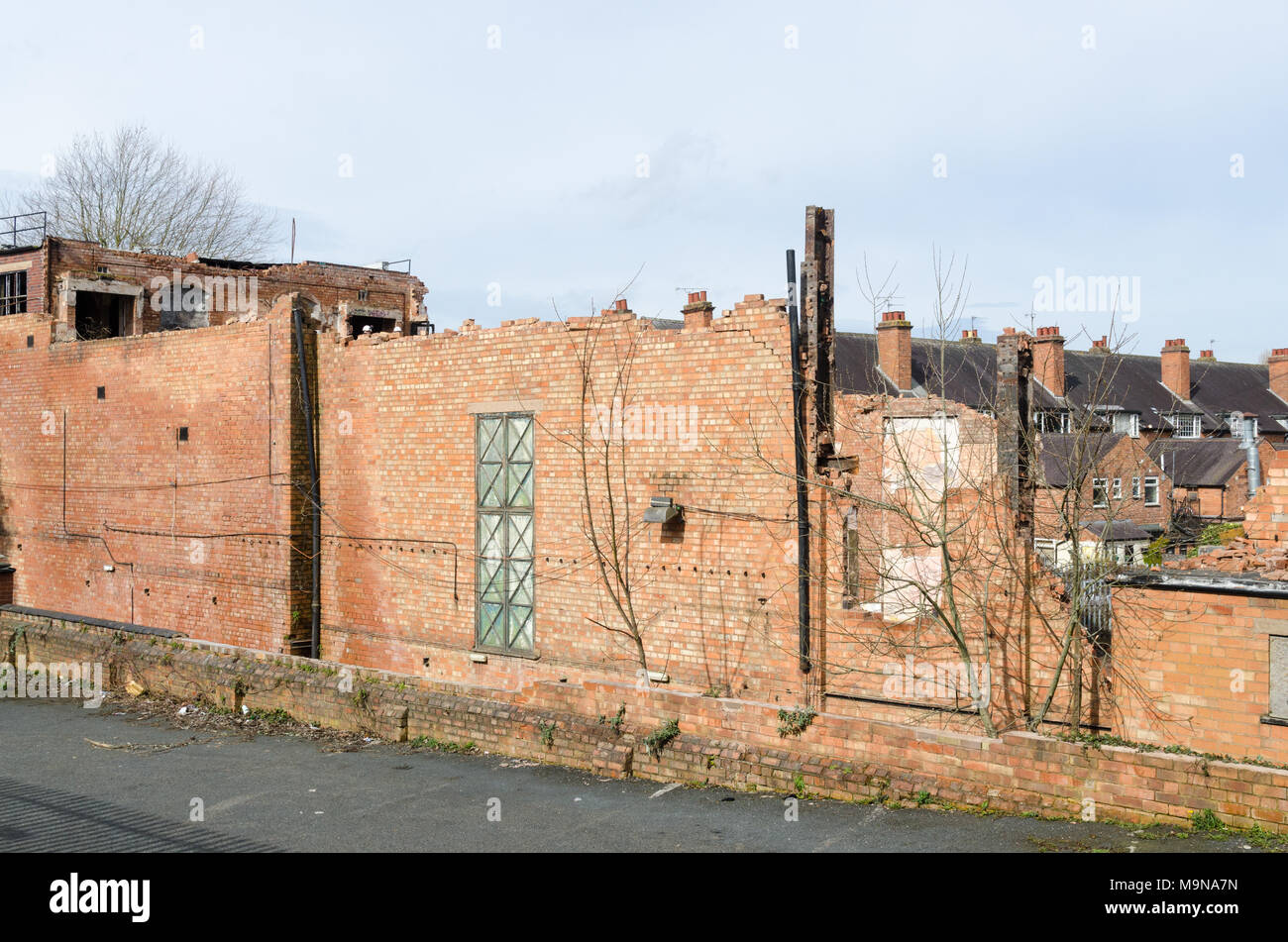 Part demolished red brick wall in Kings Heath, Birmingham Stock Photo