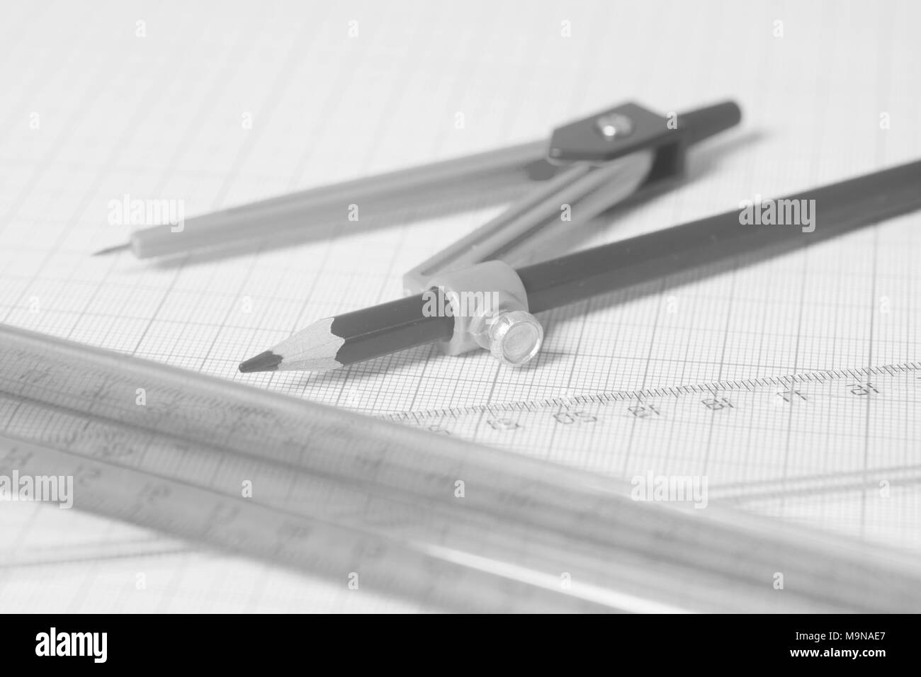 Drawing compass with black pensil and rulers on graph paper.Engineering concept Stock Photo Alamy