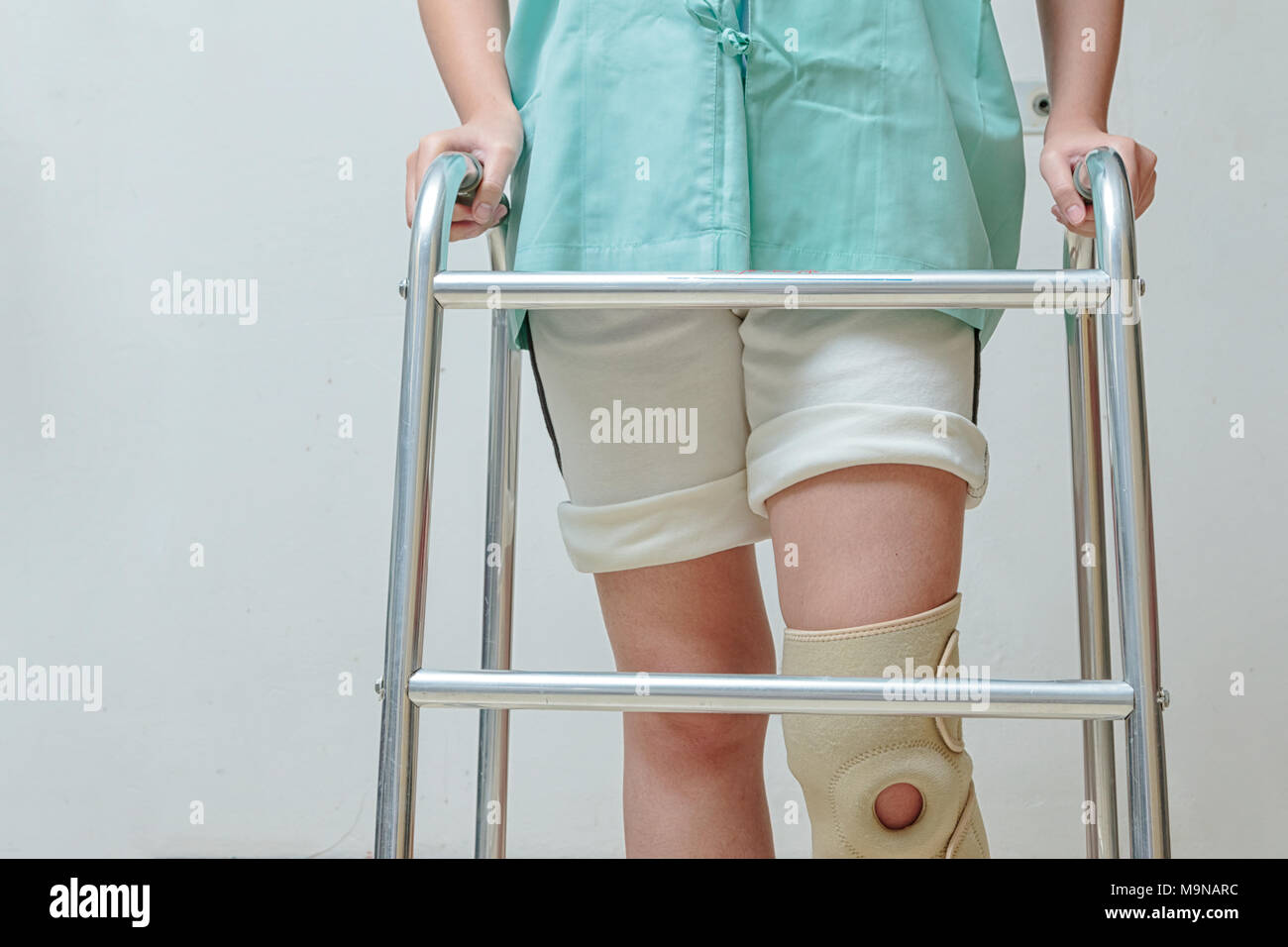 Asian woman patient with knee brace with walking stick and knee braces  support in hospital ward after ligament surgery Stock Photo - Alamy