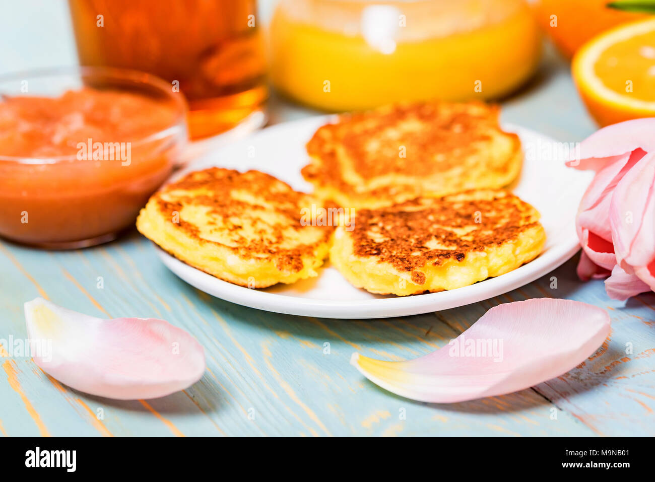 Cottage cheese cakes, honey, quince jam, flower Stock Photo Alamy