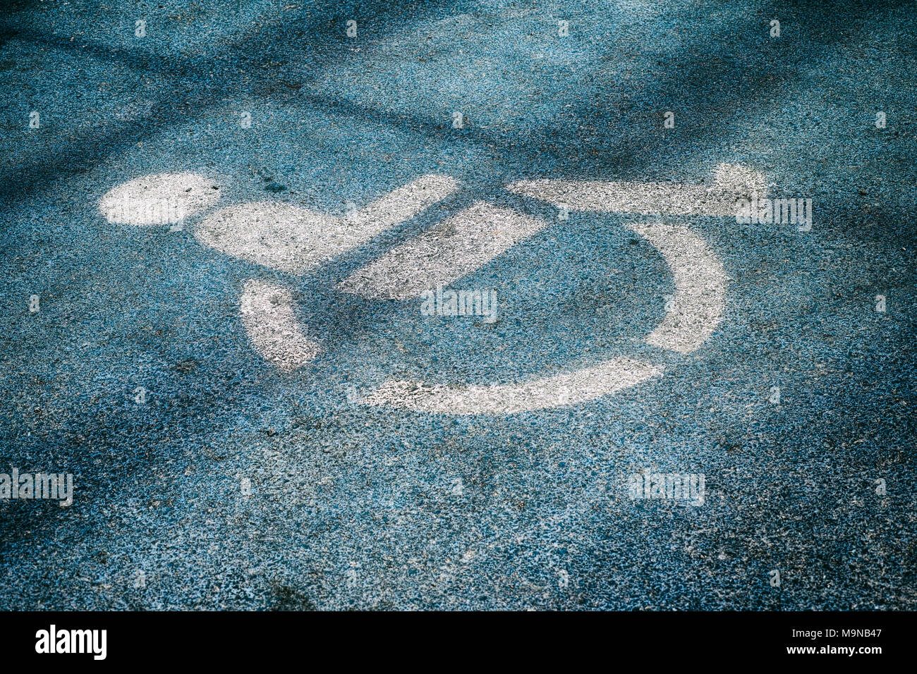 Disabled parking sign drawing on the ground. Close-up Stock Photo - Alamy