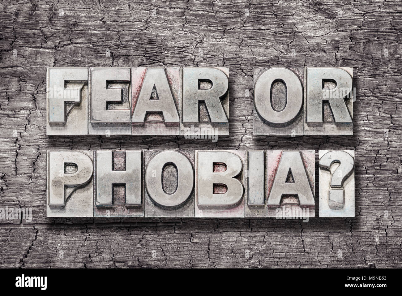 fear or phobia question made from vintage letterpress type on burned wood background Stock Photo