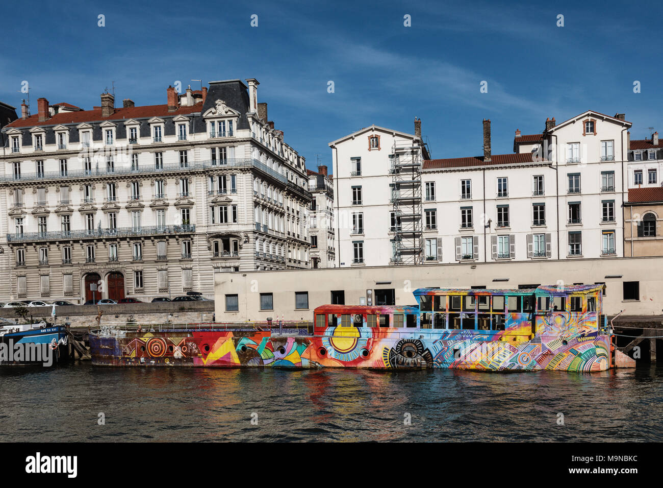 A colourful barge on the Saone river taken from a pleasure cruiser boat, Lyon, France. Stock Photo