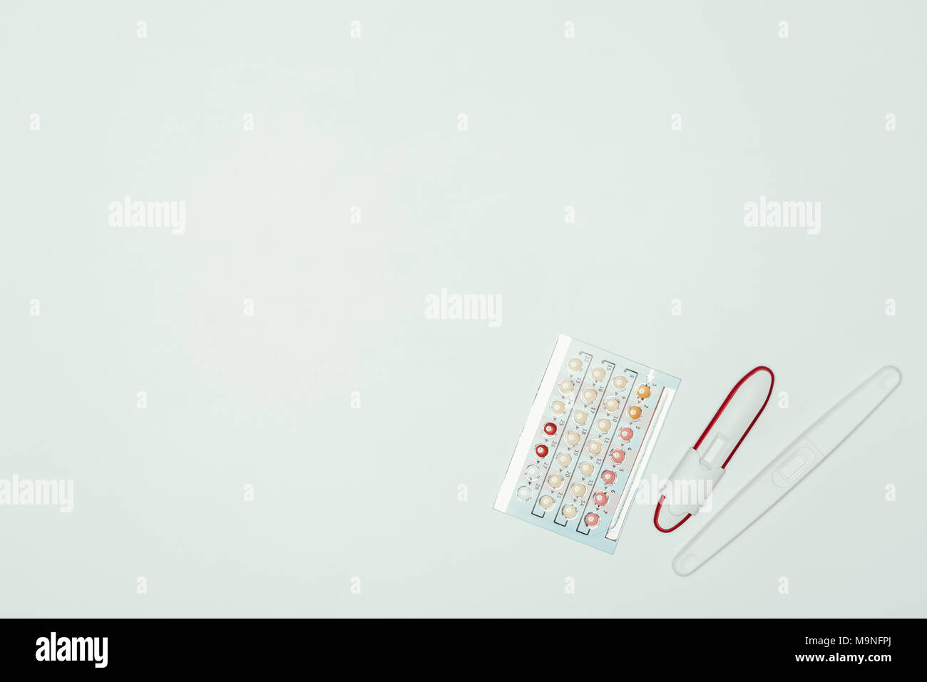 top view of contraceptive pills and pregnancy test isolated on grey Stock Photo