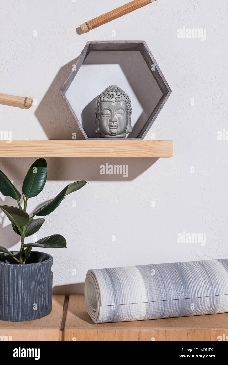 yoga mat under sculpture of buddha head in frame Stock Photo Alamy