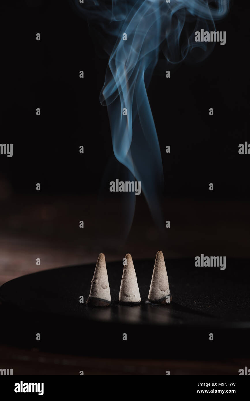 three burning incense sticks with smoke Stock Photo Alamy