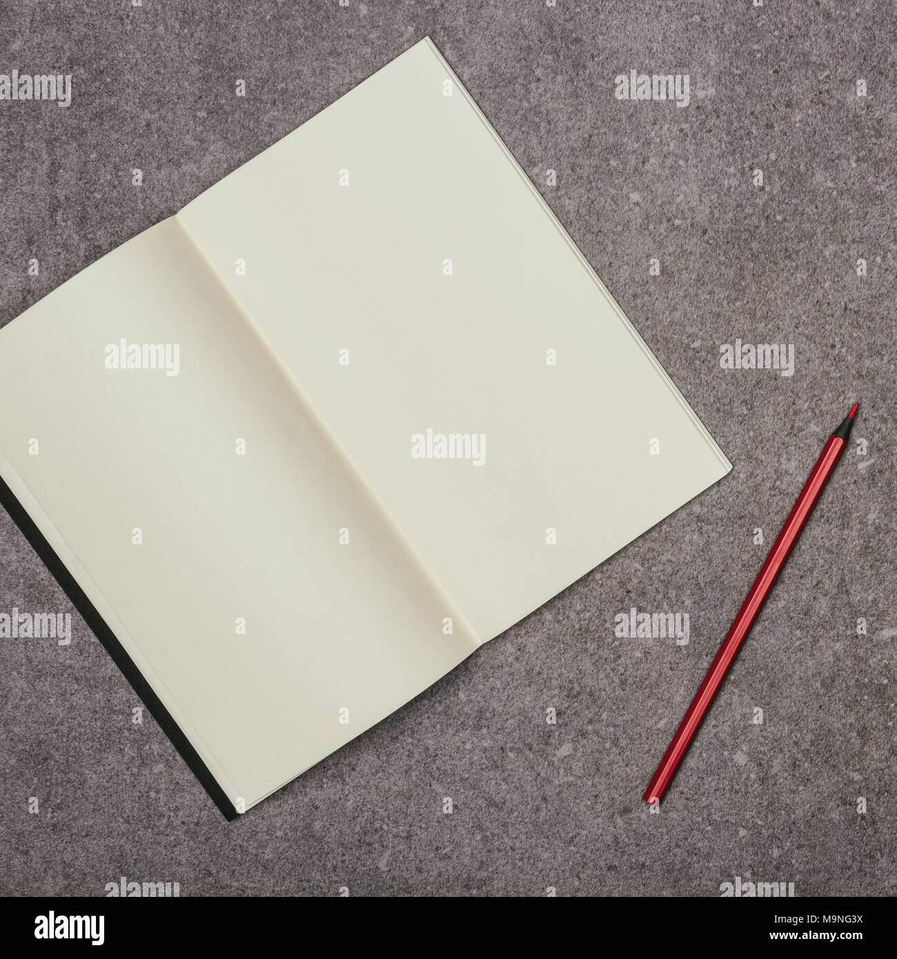 close up view of blank notebook and marker on grey surface Stock Photo