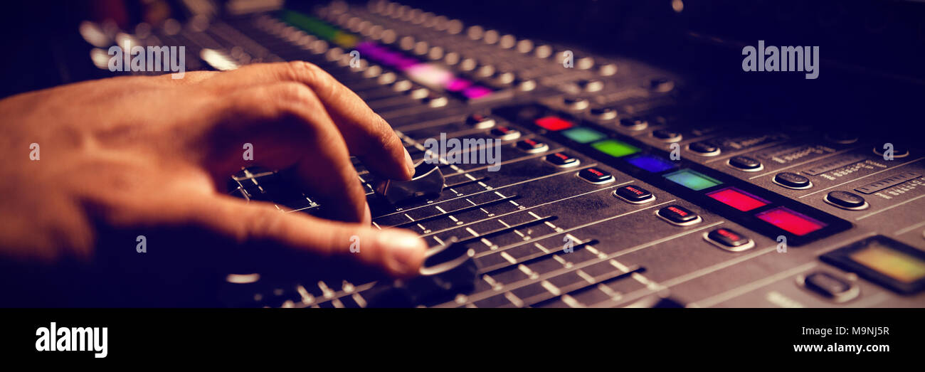 Cropped hand of musician using sound mixer Stock Photo