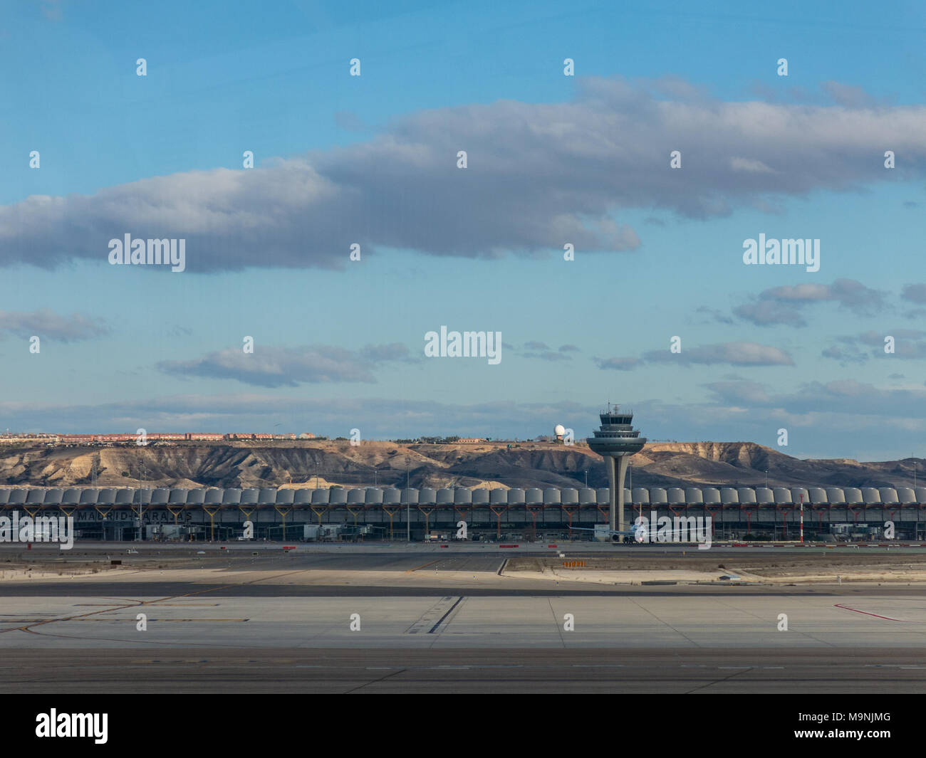 A plane prepares to take off on the runway of Terminal T4 the Adolfo Suarez Madrid Barajas Airport. Barajas is the main international airport serving Stock Photo