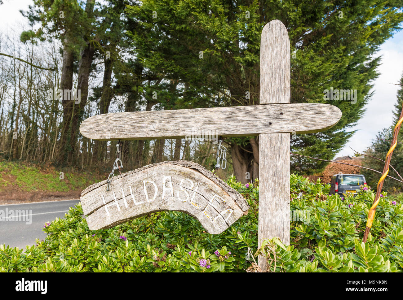 Rustic wooden signpost with house name outside a house in England, UK. Stock Photo