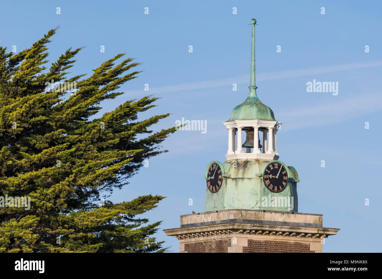 Clock tower and bell tower of a British Victorian building. Located over the Rustington Convalescent Home in Rustington, West Sussex, England, UK. Stock Photo