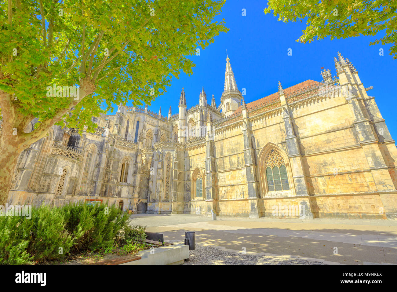 Medieval Batalha Monastery in Gothic and Manueline architecture in Batalha city, central Portugal. Dominican convent of Saint Mary of the Victory popular landmark and Unesco Heritage. Blue sky. Stock Photo