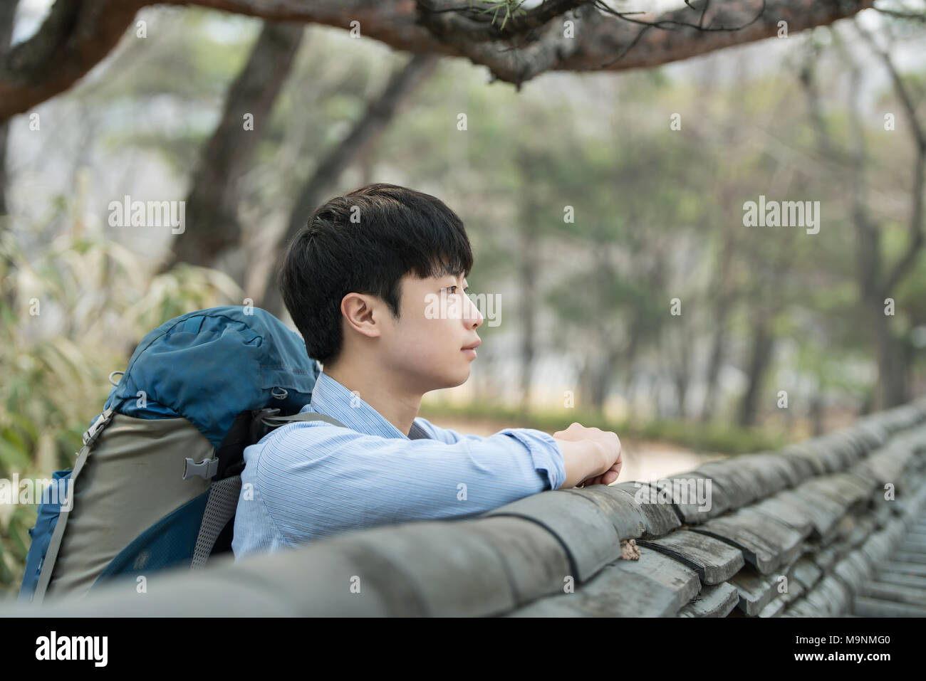 A Young Man Doing A Backpacking Trip In A Korean Traditional House