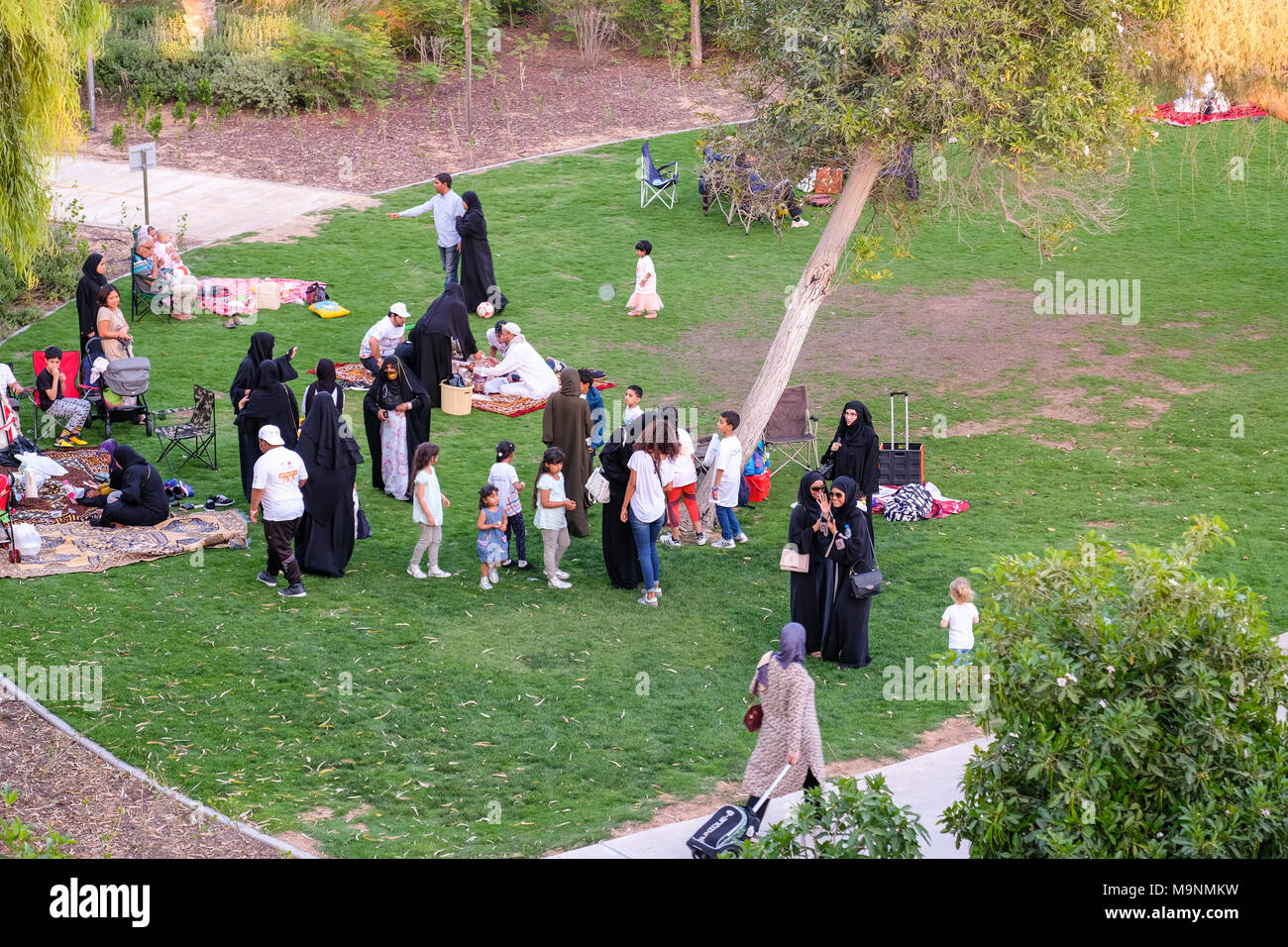Outdoor Family Picnic , Muslim Arab Families enjoying outdoor Activities at Umm Al Emarat Park, Abu Dhabi, UAE. Stock Photo