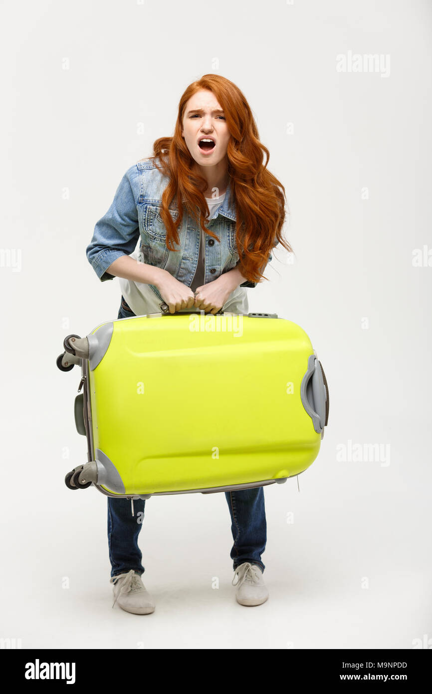 Lifting heavy suitcase hires stock photography and images Alamy