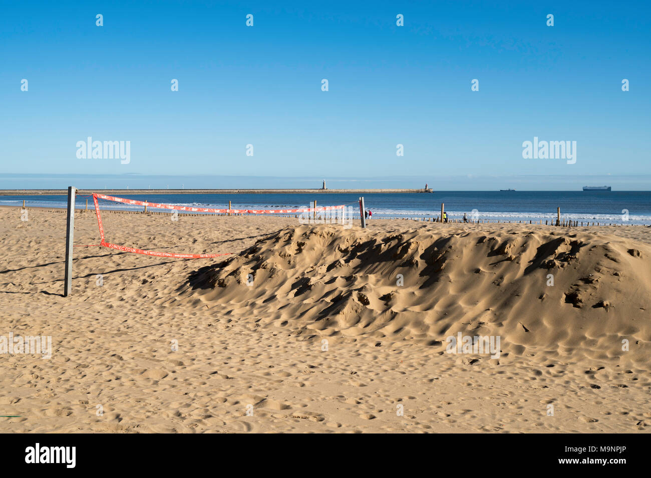 A volleyball court on South Shields seafront, covered in sand following easterly gales, north east England, UK Stock Photo