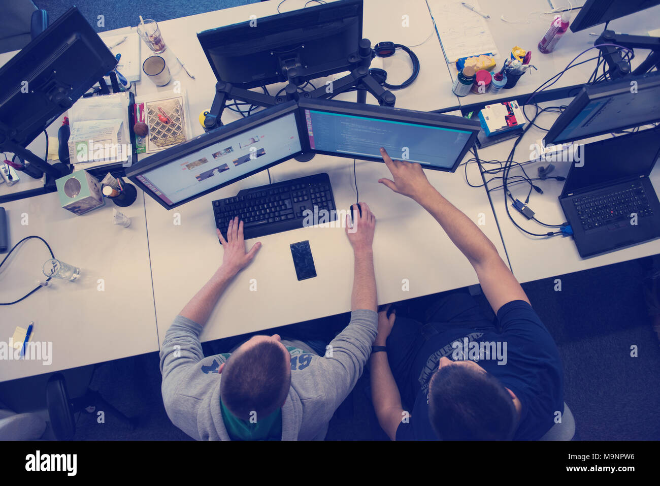 top view of software developers writing programming code on computer Stock Photo