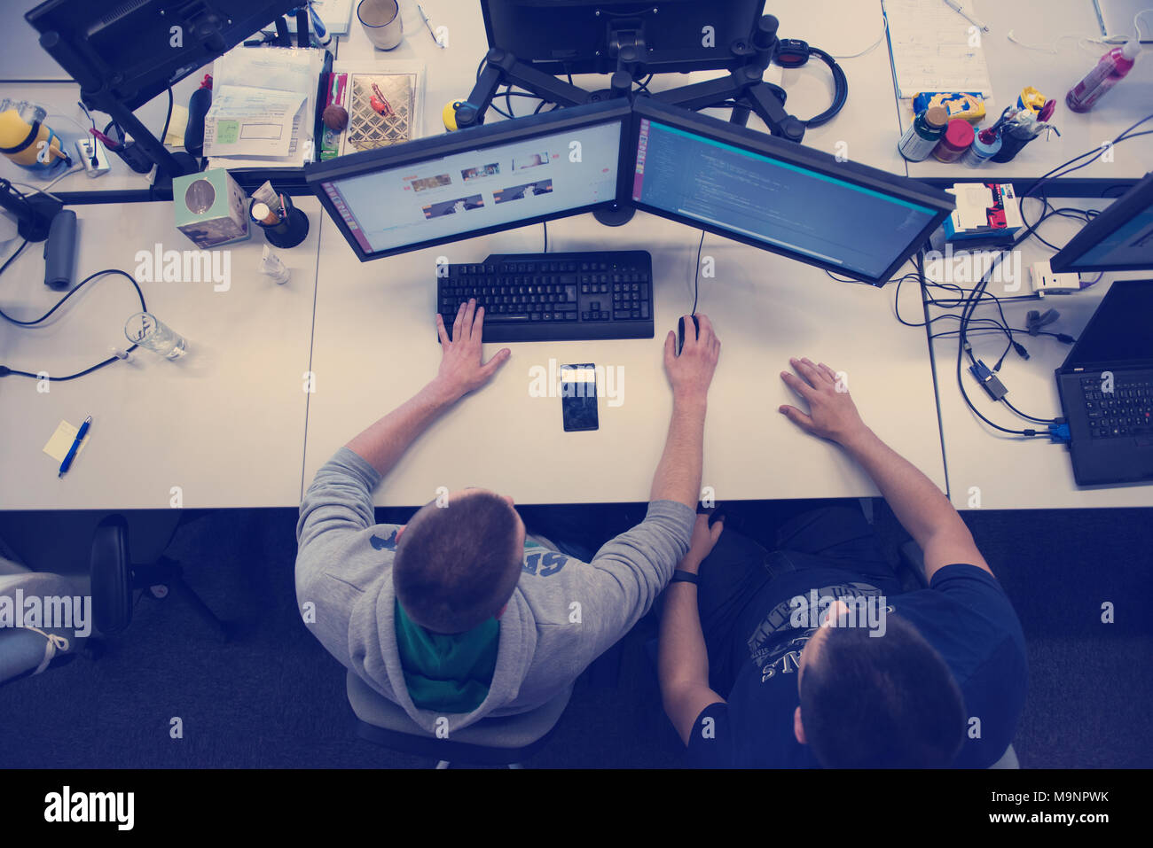 top view of software developers writing programming code on computer Stock Photo