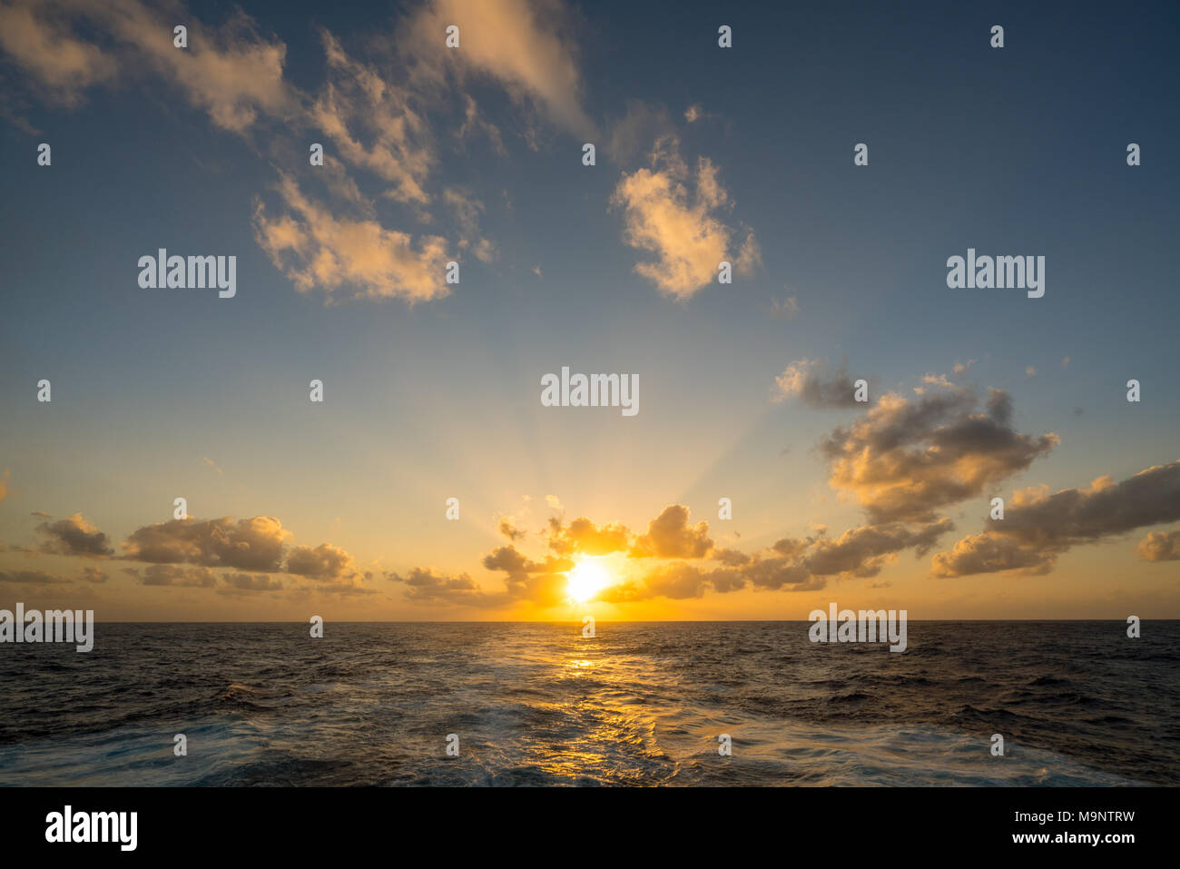 Sunset behind a cruising cruise ship at sea Stock Photo - Alamy