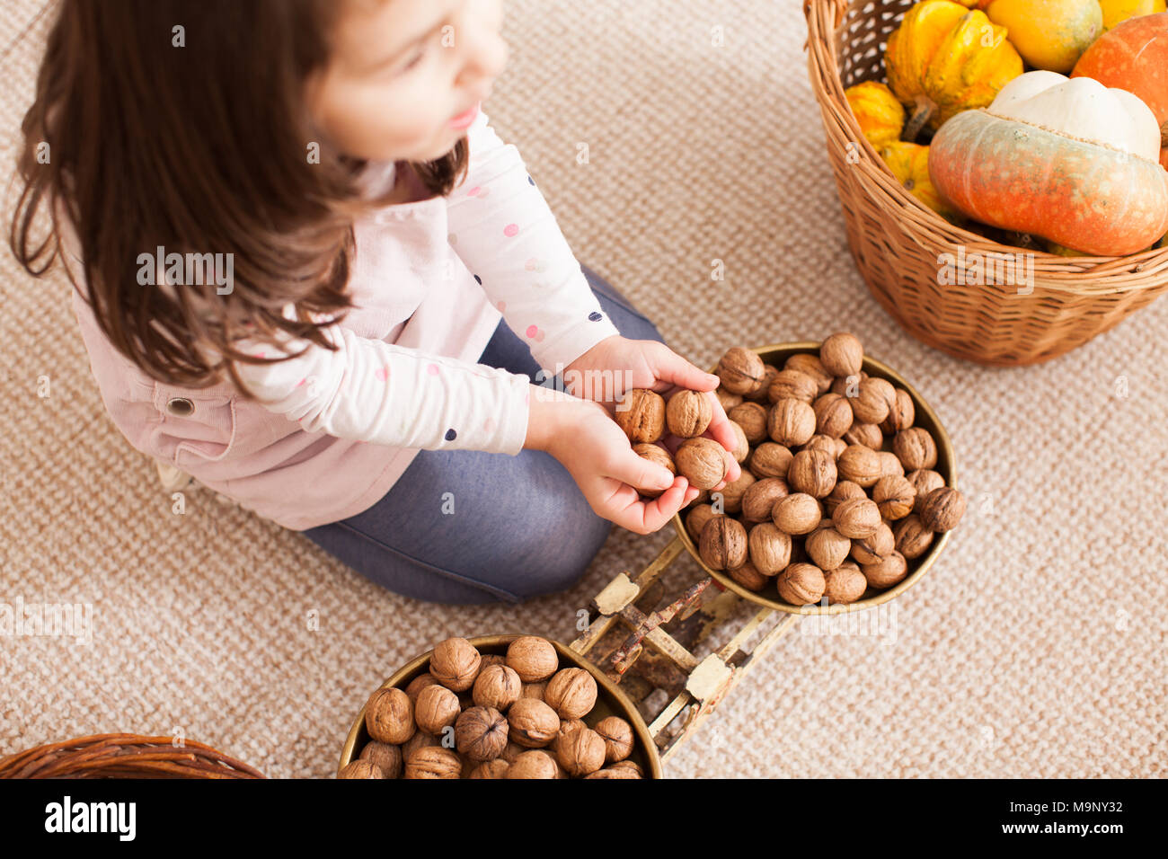 cute little girl is playing with scales Stock Photo